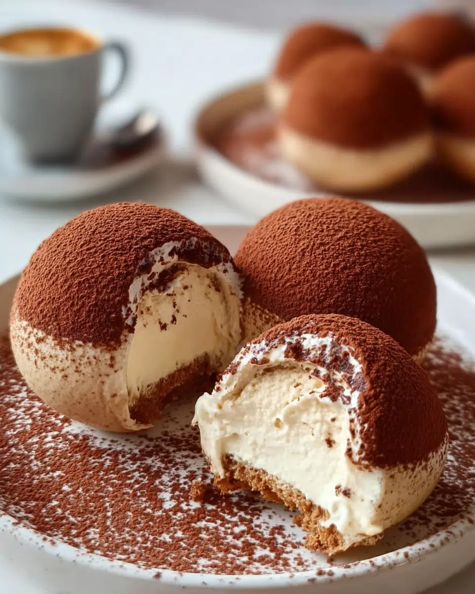 Cocoa-Dusted Tiramisu Domes elegantly plated with cocoa powder finish